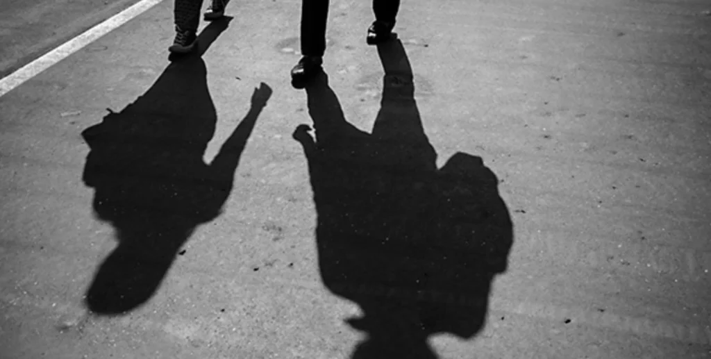 shadows of two people walking