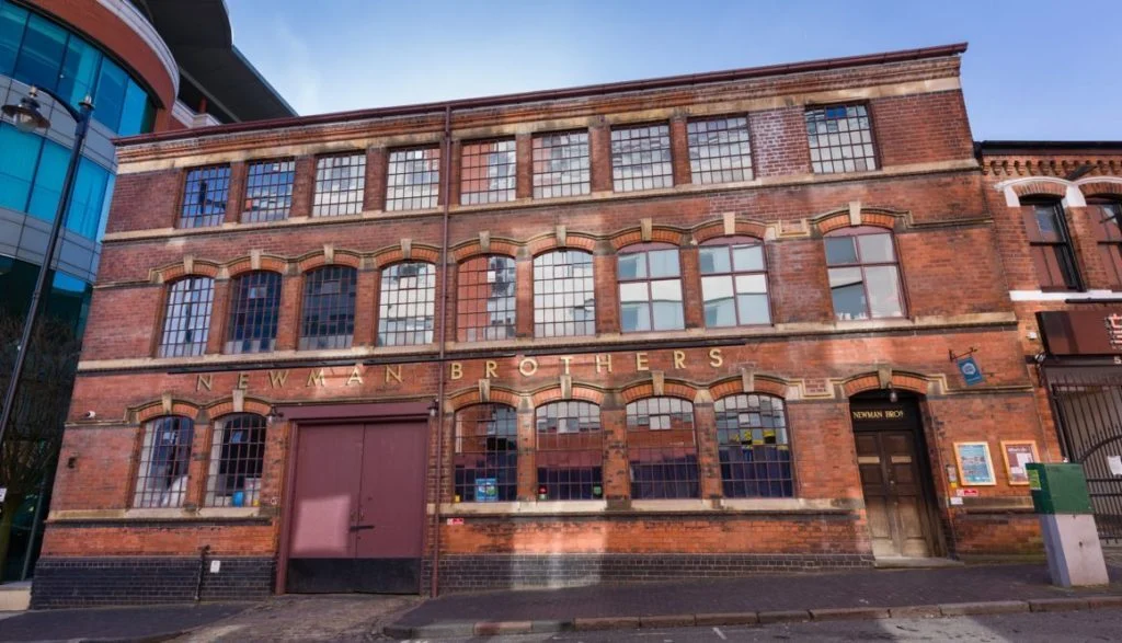 A large red brick store which is called Coffin Works