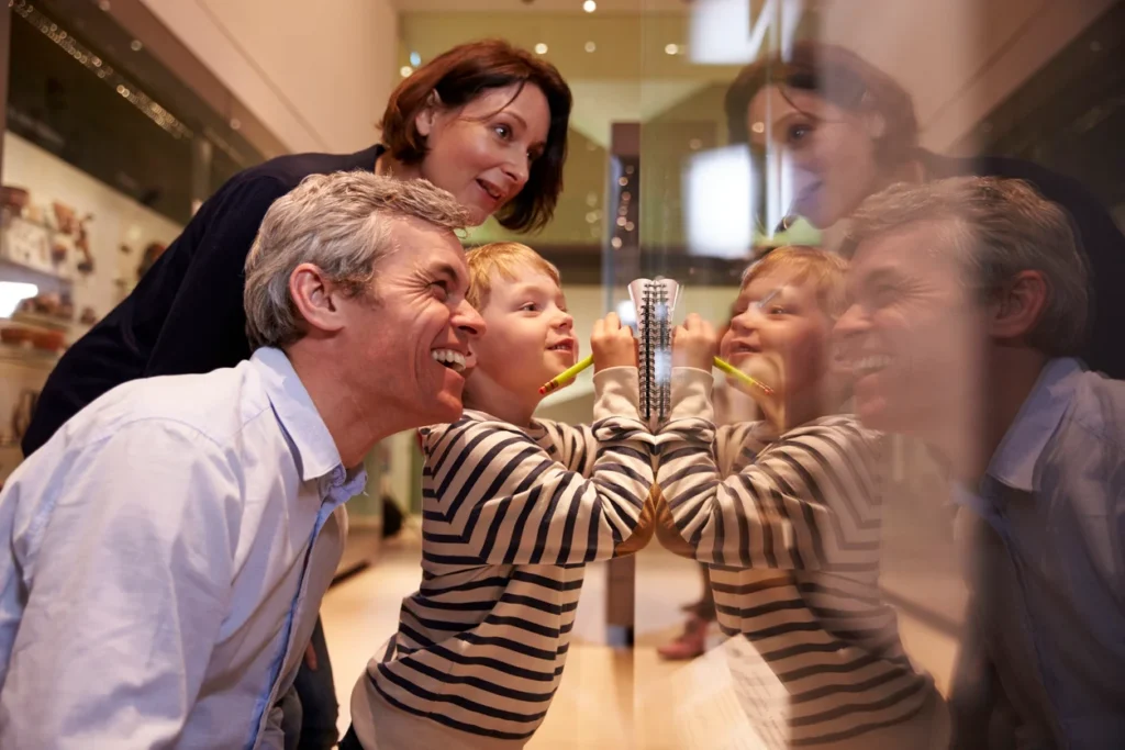 A family looking at a case of artifacts in a museum